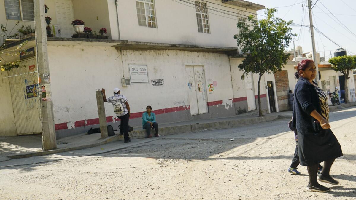 Locals cross the street in Lo de Juarez, a small community in Guanajuato. Hundreds of nearby auto factories have transformed the town's labor force and helped curb migration to the U.S.