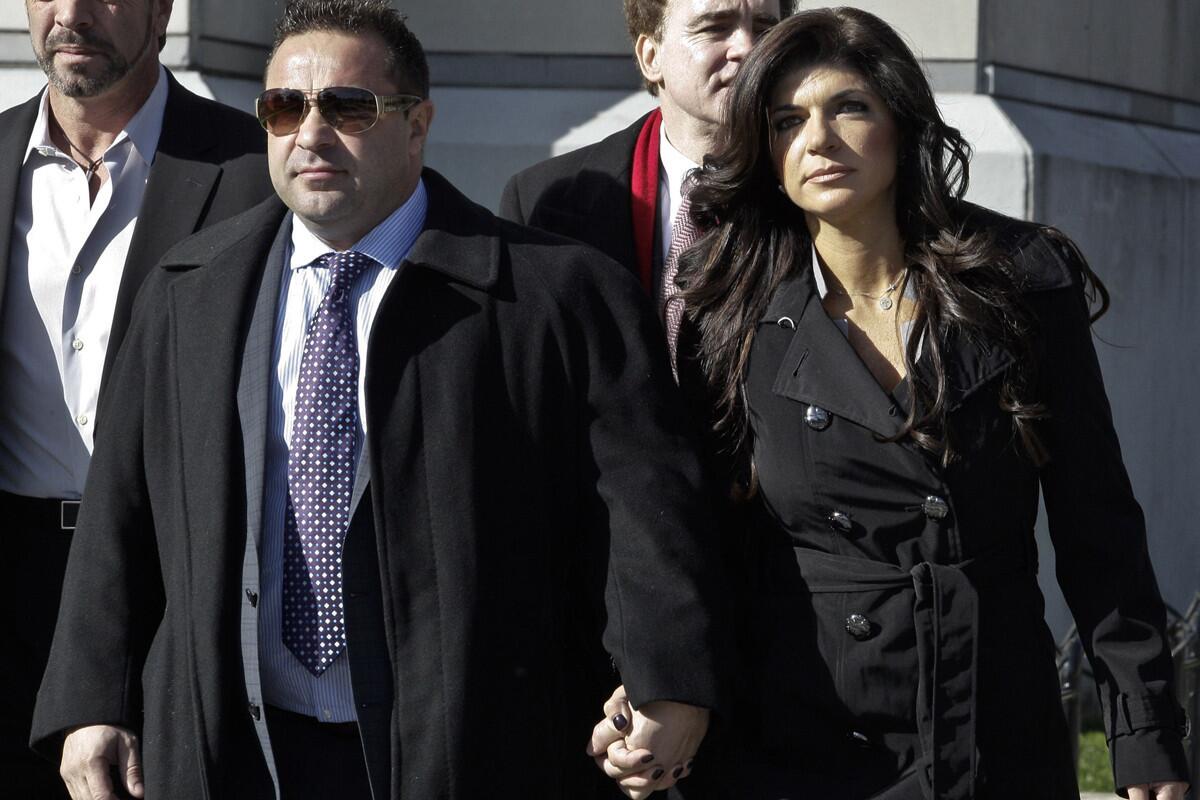 Joe Giudice and his wife, Teresa Giudice, stars of "The Real Housewives of New Jersey," leave federal court Wednesday in New Jersey.