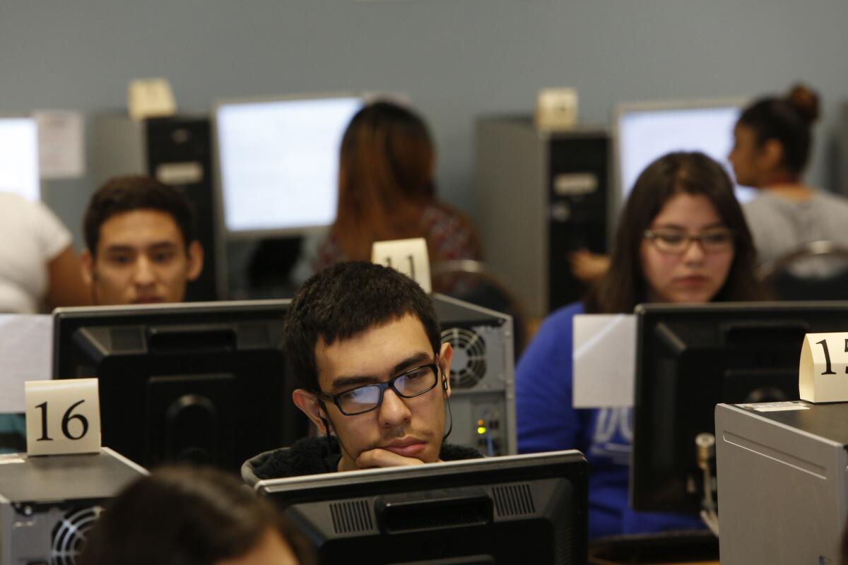 Bryan Casillas, center, concentrates as 11th-grade students at Francisco Bravo Medical Magnet High School practice last Februrary for new state standardized tests. Magnet students did comparatively well on the tests.