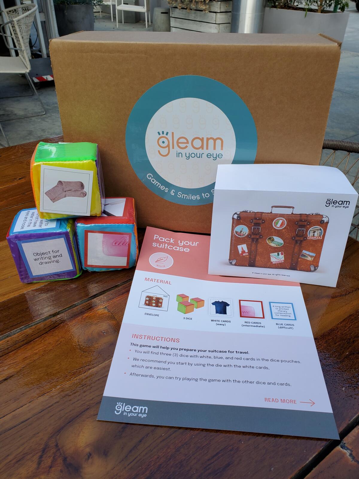The "Pack Your Suitcase" game is inside the Gleam in Your Eye box.