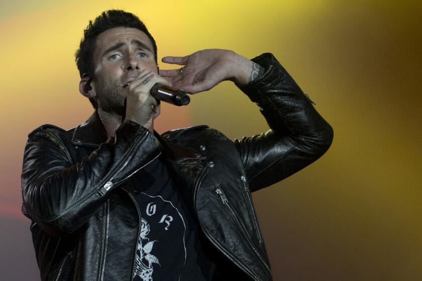 FILE - In this Sept. 16, 2017, file photo, Adam Levine of Maroon 5 performs at the Rock in Rio music festival in Rio de Janeiro, Brazil. Big Boi and Travis Scott will join Maroon 5 in this year?s Super Bowl halftime show. Maroon 5 had been the widely reported halftime show act since September, but the NFL officially announced the band as its headliner Sunday, Jan. 13, 2019. (AP Photo/Silvia Izquierdo, File)
