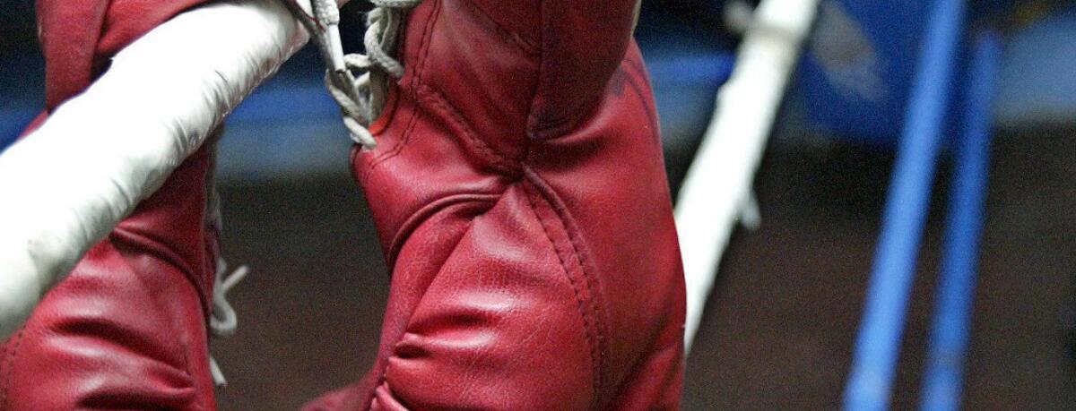 Boxing gloves are left on a training ring in a gym in Manila, Philippines.
