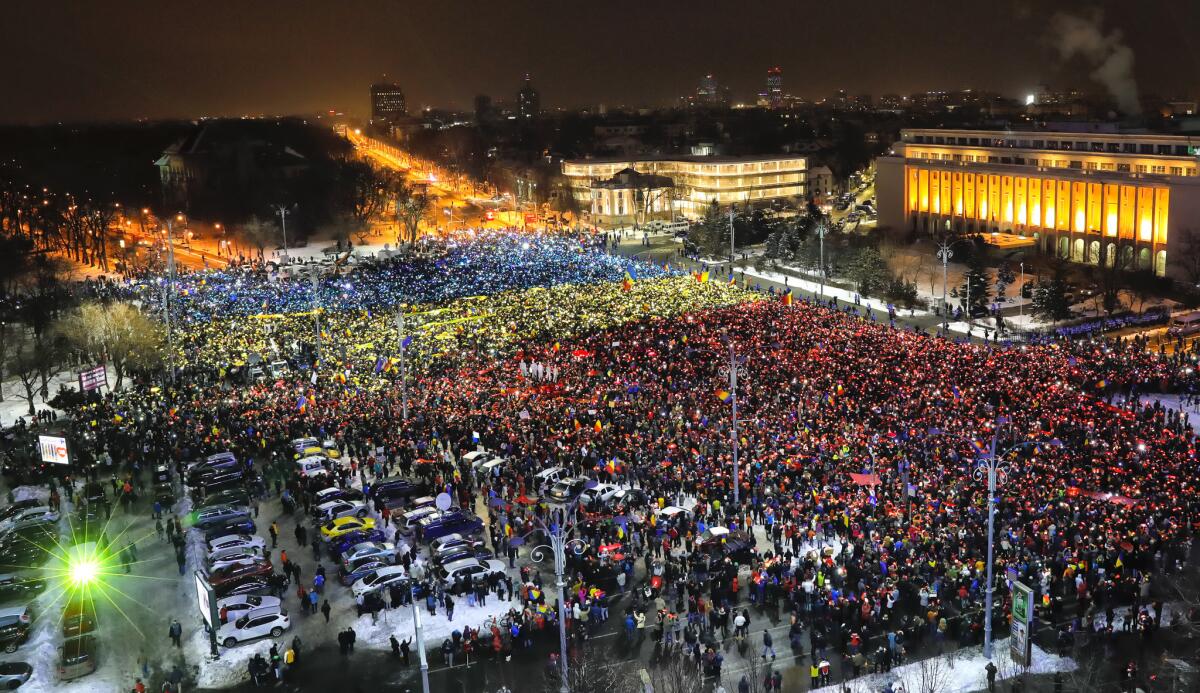 Protesters light the flashes of their mobile phones in the colors of Romania's flag during an anti-government demonstration in Bucharest on Sunday.