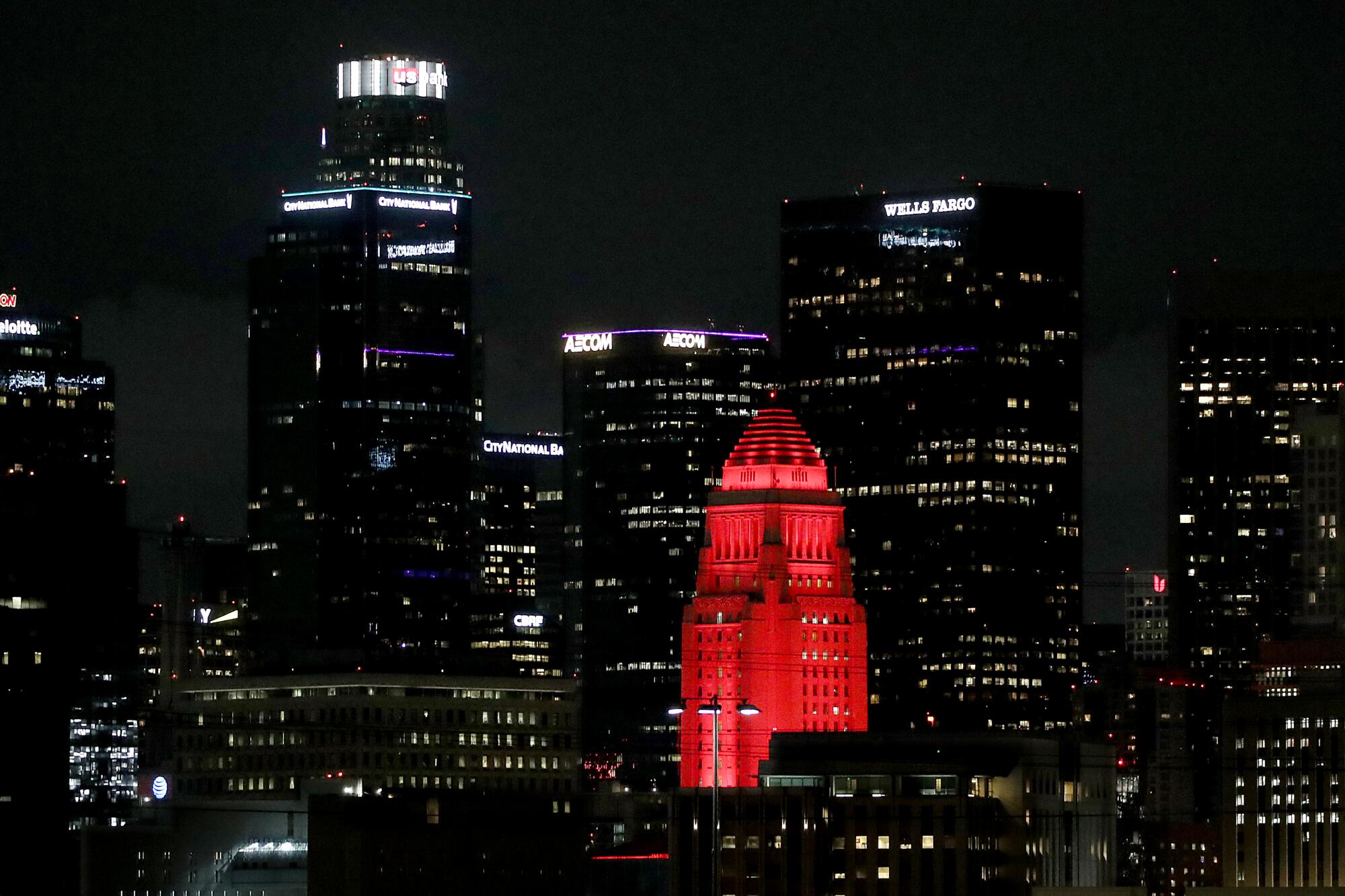A building is lighted red at night.
