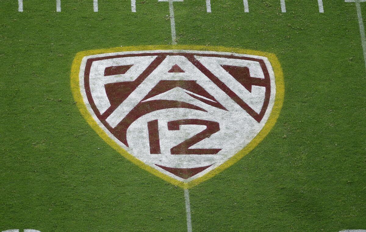 The Pac-12 logo on a football field.