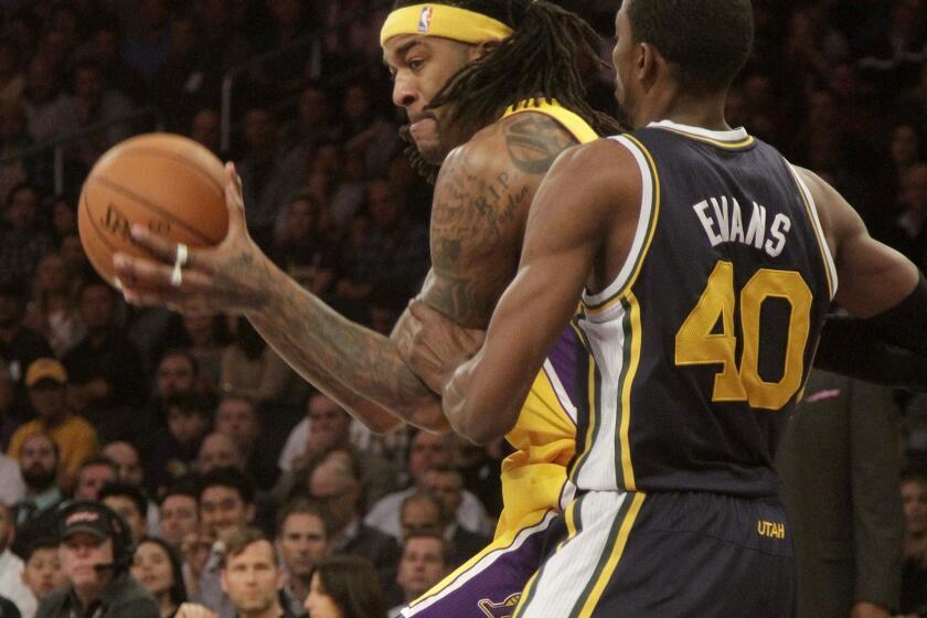 Jordan Hill works against Utah's Jeremy Evans during the Lakers' matchup Tuesday with the Jazz at Staples Center.