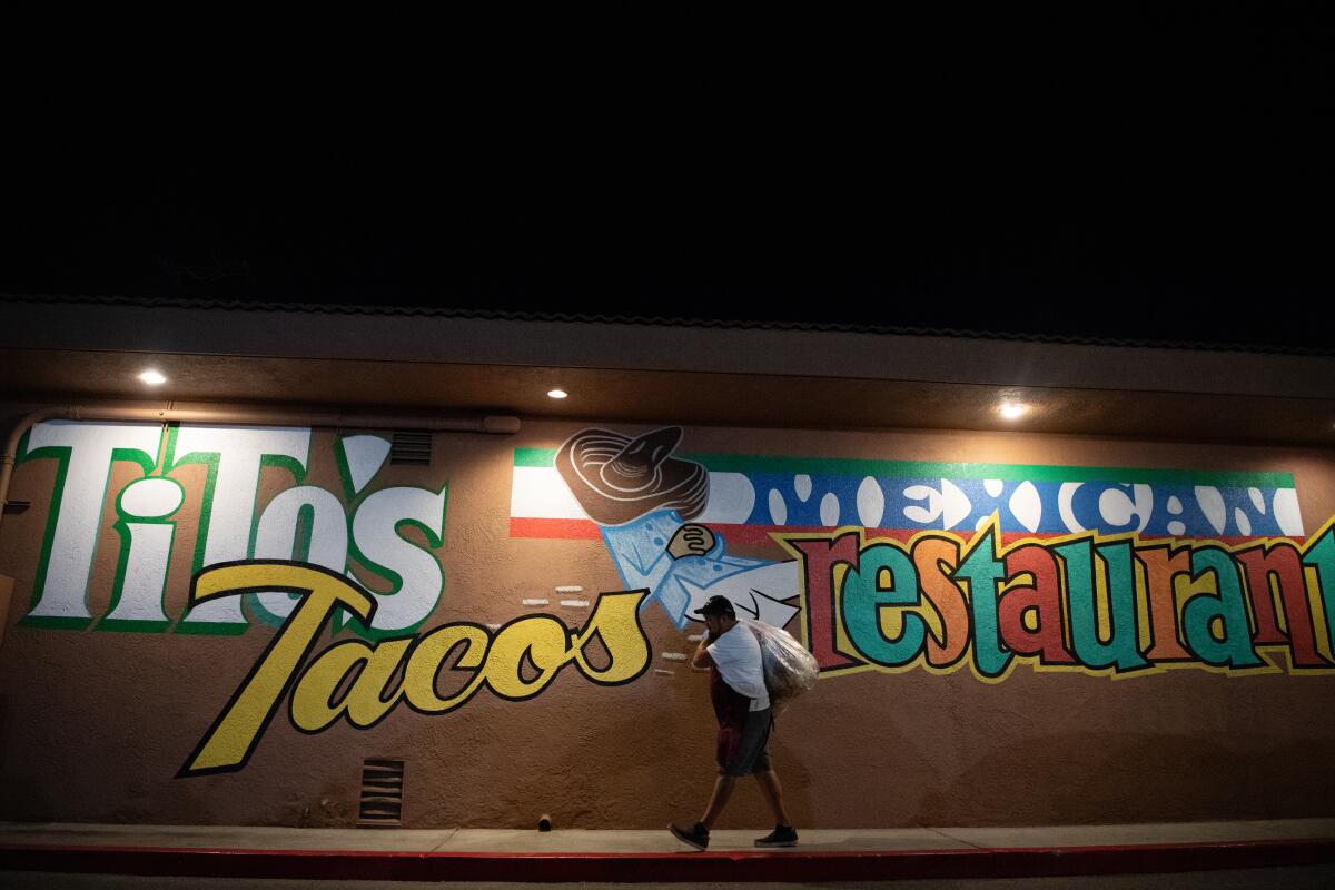 Employees begin to close up shop at Tito's Tacos.