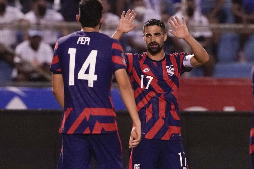 United States' Sebastian Lletget, right, celebrates with his teammate Ricardo Pepi after scoring his side's fourth goal against Honduras during a qualifying soccer match for the FIFA World Cup Qatar 2022, in San Pedro Sula, Honduras, Wednesday, Sept. 8, 2021. (AP Photo/Moises Castillo)