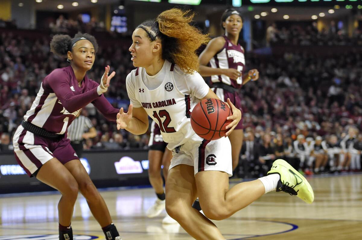 FILE - In this March 8, 2020, file photo, South Carolina's Brea Beal (12) drives while defended by Mississippi State's Myah Taylor (1) during a championship match at the Southeastern Conference women's NCAA college basketball tournament in Greenville, S.C. South Carolina is ranked No. 1 in the women's NCAA college basketball poll released Tuesday, Nov. 10, 2020.(AP Photo/Richard Shiro, File)