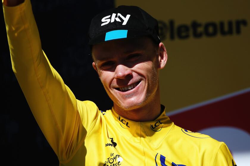 Overall leader Chris Froome celebrates on the podium after the 20th stage of the Tour de France on Saturday.