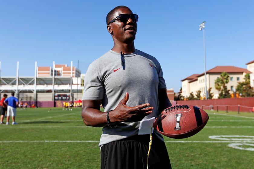 LOS ANGELES, CALIF. -- THURSDAY, AUGUST 17, 2017: University of Southern California running back coach Deland McCullough shown with the Fumble Pro, used to improve ball security, after practice on the campus of the University of Southern California in Los Angeles, Calif., on Aug. 17, 2017. (Gary Coronado / Los Angeles Times)