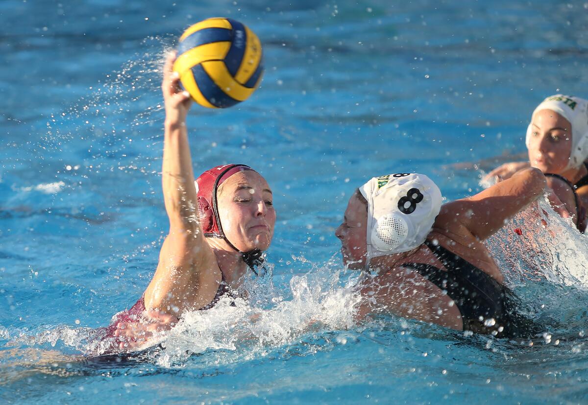 Laguna Beach's Emma Singer, left, scores on a close-range shot while Mira Costa's Dylan Read defends in a nonleague match at home Friday.