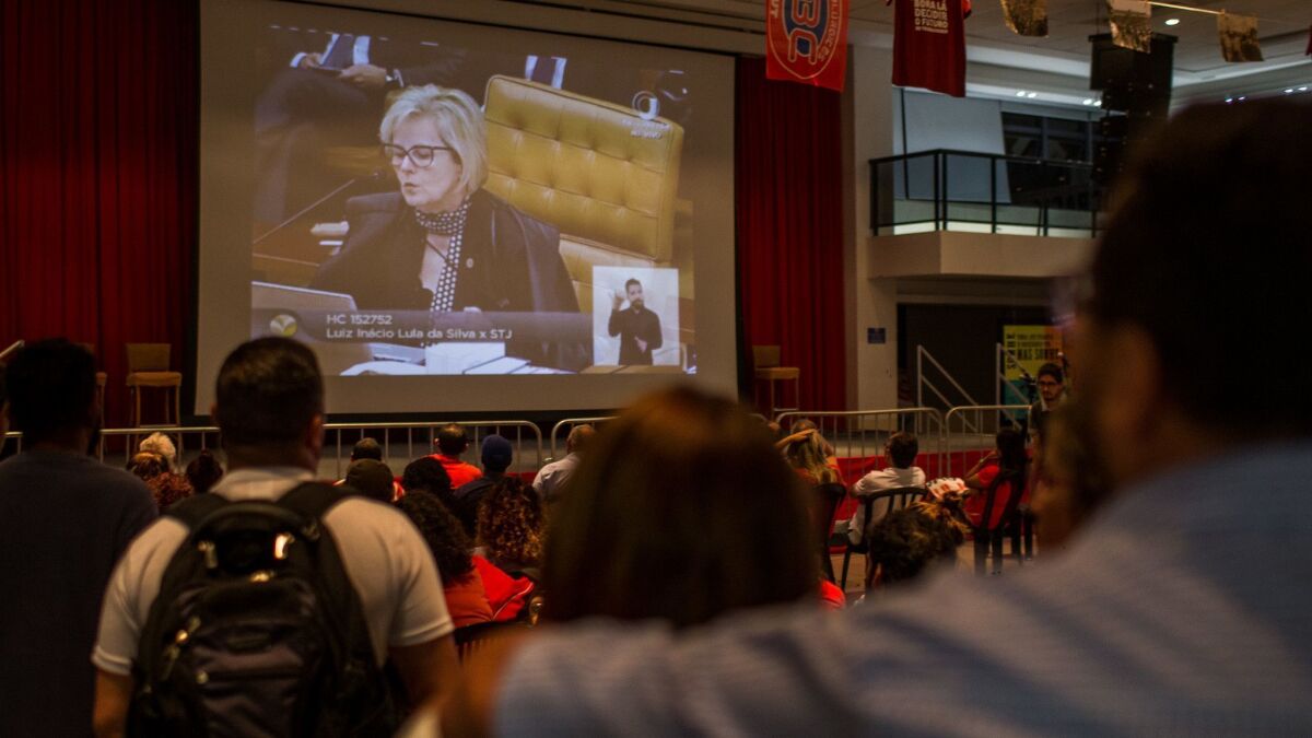 Supporters of former president Luiz Inacio Lula da Silva watch Justice Rosa Weber at a session of the Federal Supreme Court on a large screen television at the headquarters of the Metalworkers' Union on April 4, 2018 in Sao Paulo, Brazil.