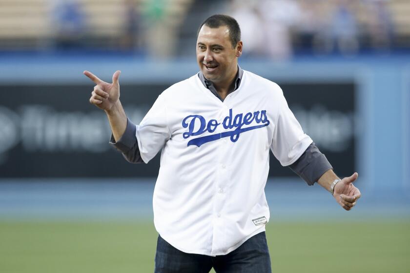 USC Coach Steve Sarkisian reacts after throwing out the first pitch at the Dodgers game April 28.