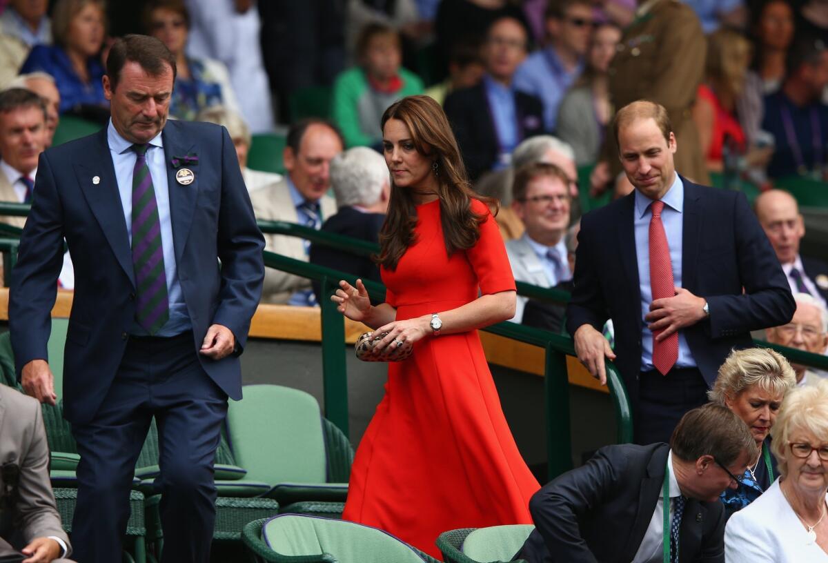 All England Lawn Tennis Club Chairman Philip Brook, left accompanies Catherine, the Duchess of Cambridge (wearing an L.K. Bennett dress) and Prince William, Duke of Cambridge, to Day Nine of the Wimbledon Lawn Tennis Championships.