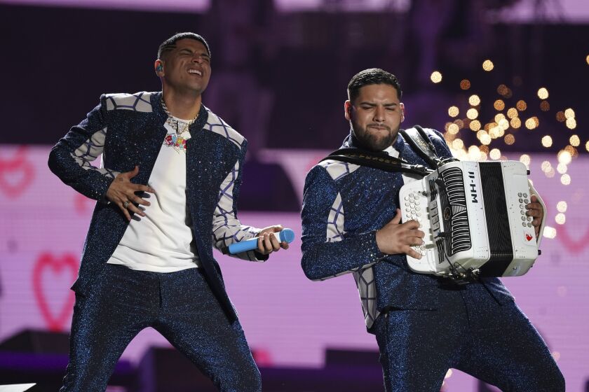Vocalist Eduin Caz, left, and accordionist Dylan Camacho, of the regional Mexican music ensemble "Grupo Firme."