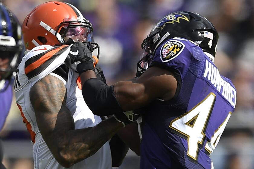 FILE - In this Sunday, Sept. 29, 2019, file photo, Cleveland Browns wide receiver Odell Beckham, center, and Baltimore Ravens cornerback Marlon Humphrey (44) grab each other during the second half of an NFL football game in Baltimore. Browns coach Freddie Kitchens wants more consistent NFL officiating after wide receiver Odell Beckham Jr. was choked during Sunday’s game. Beckham got into a skirmish with Ravens cornerback Marlon Humphrey, who pinned the three-time Pro Bowler and had his hands around his neck before being pulled away. Both players were assessed personal fouls, but neither was ejected. Kitchens said he planned to reach out to the league about that situation in particular and officiating evenness in general. (AP Photo/Nick Wass, File)