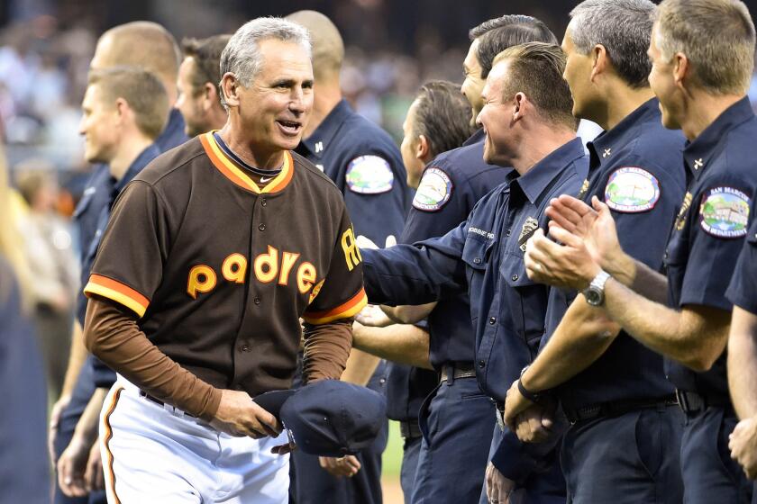 SAN DIEGO, CA - MAY 24: San Diego Padres manager Bud Black #20, left, greets San Diego area firefighters before a baseball game against the Chicago Cubs at Petco Park May 24, 2014 in San Diego, California.