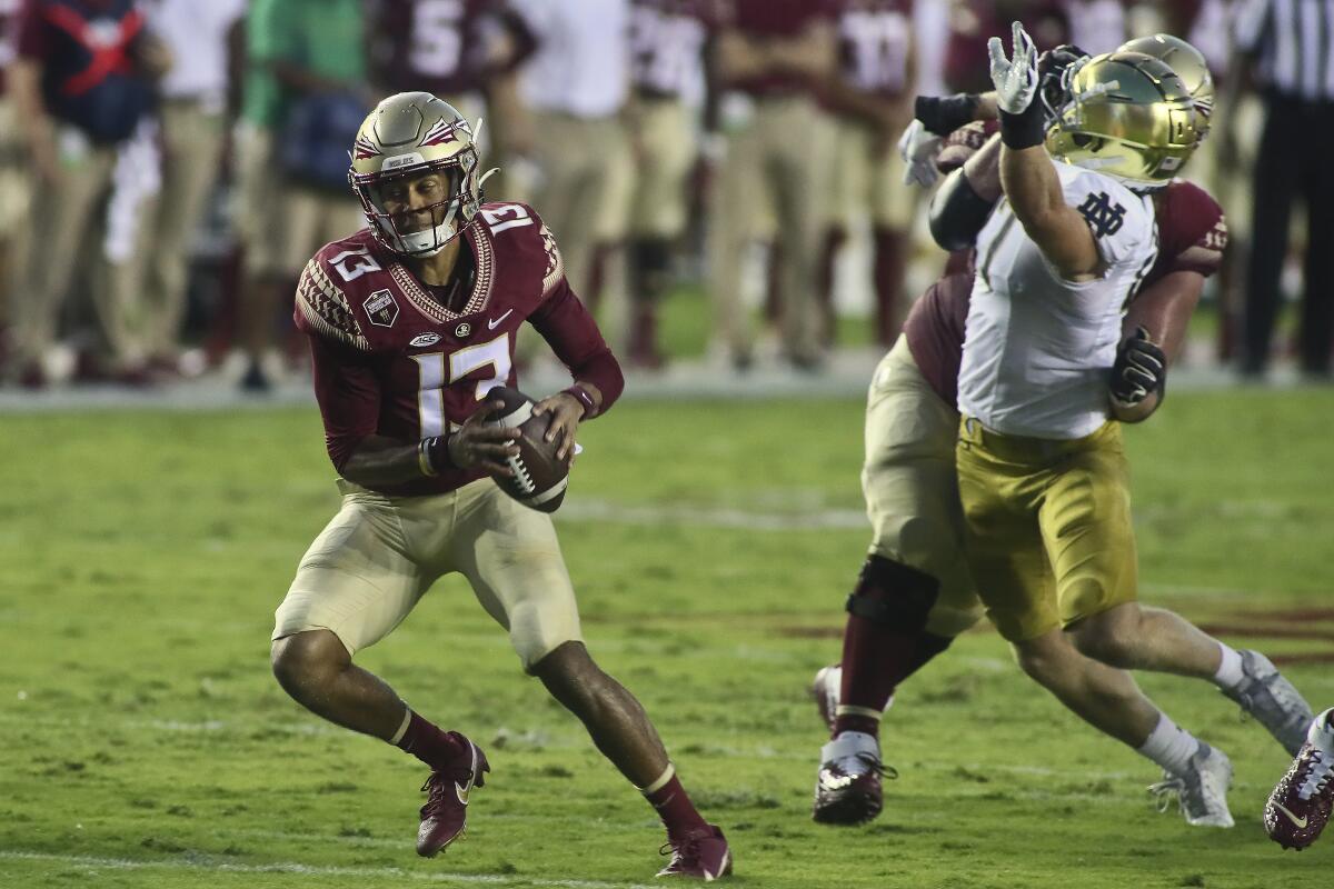 Florida State quarterback Jordan Travis (13) scrambles in the first quarter of an NCAA college football game Sunday, Sept. 5, 2021, in Tallahassee, Fla. (AP Photo/Phil Sears)