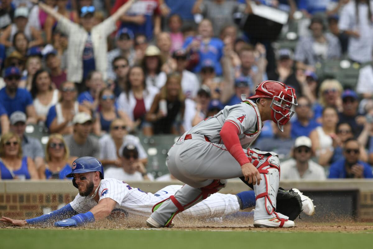 Chicago's Miles Mastrobuoni, left, slides safely into home plate as Angels catcher Logan O'Hoppe, right, waits for the throw.