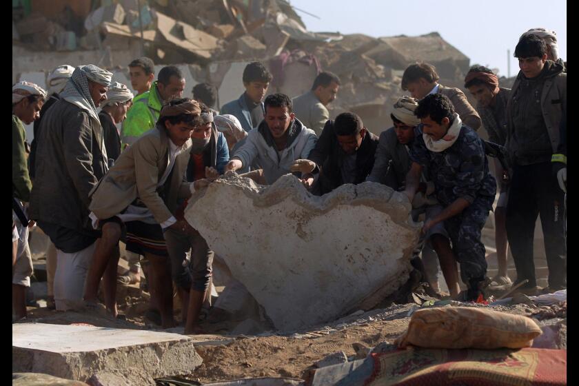 Yemeni civilians and security forces search for survivors in the rubble of buildings destroyed during Saudi airstrikes near Sana Airport on March 26.