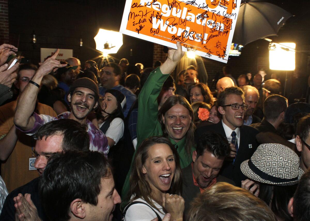 Amendment 64 supporters celebrate after a local television station announced the marijuana amendment's passage, in Denver, Colo.