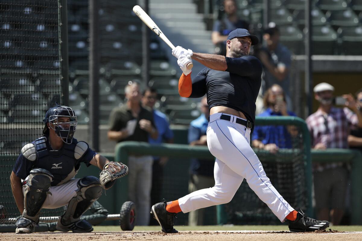 Former NFL quarterback Tim Tebow takes batting practice during a private baseball tryout at USC on Aug. 30.