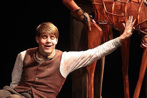 Andrew Veenstra (playing Albert Narracott) closes his eye as he reaches out to touch Joey for the first time in the Tony-winning play "War Horse" at the Ahmanson Theatre.