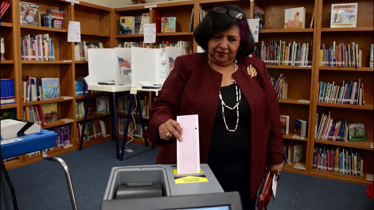 City Council candidate Gloria Molina casts her ballot at Sierra Vista Elementary School in El Sereno.