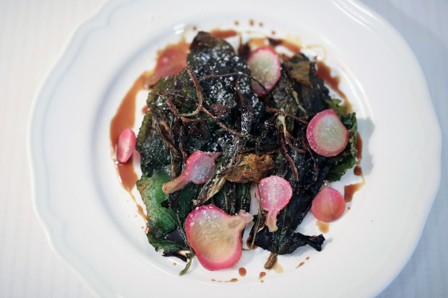 A dish consisting of "Winter herbs with pickled radish and turnip, laban jameed and dibes" in the kitchen of Fawda restaurant, in Bethlehem, West Bank.