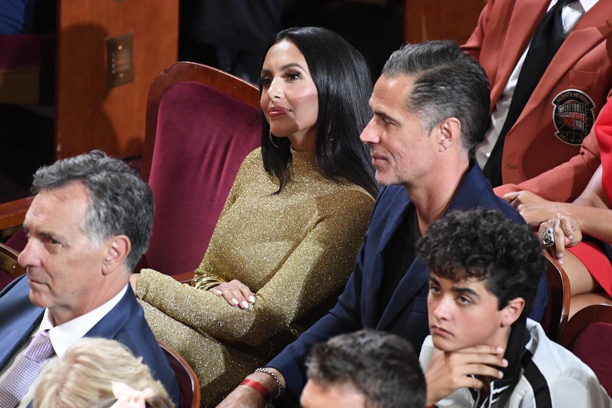 Vanessa Bryant and Rob Pelinka sit in an audience.