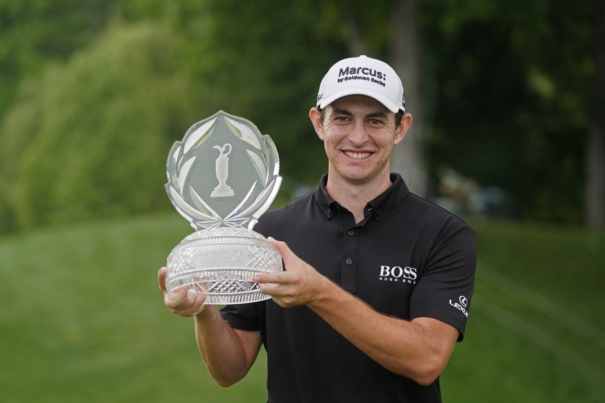 Patrick Cantlay holds the trophy after winning the Memorial golf tournament, Sunday, June 6, 2021, in Dublin, Ohio. (AP Photo/Darron Cummings)