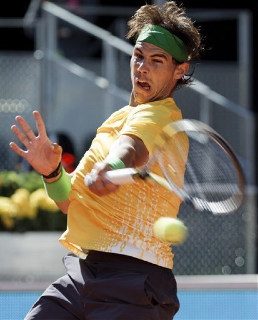 Rafael Nadal from Spain returns the ball during the Madrid Open tennis tournament against Marcos Baghdatis from Cyprus, in Madrid, Wednesday, May 4, 2011.(AP Photo/Daniel Ochoa de Olza)