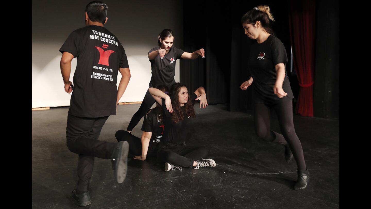 Estancia High School drama students perform a scene during rehearsals for "To Whom It May Concern," an original play written by the students that they will be performing from January 17-19. Their show shirts were designed by student Justin Marroquin.