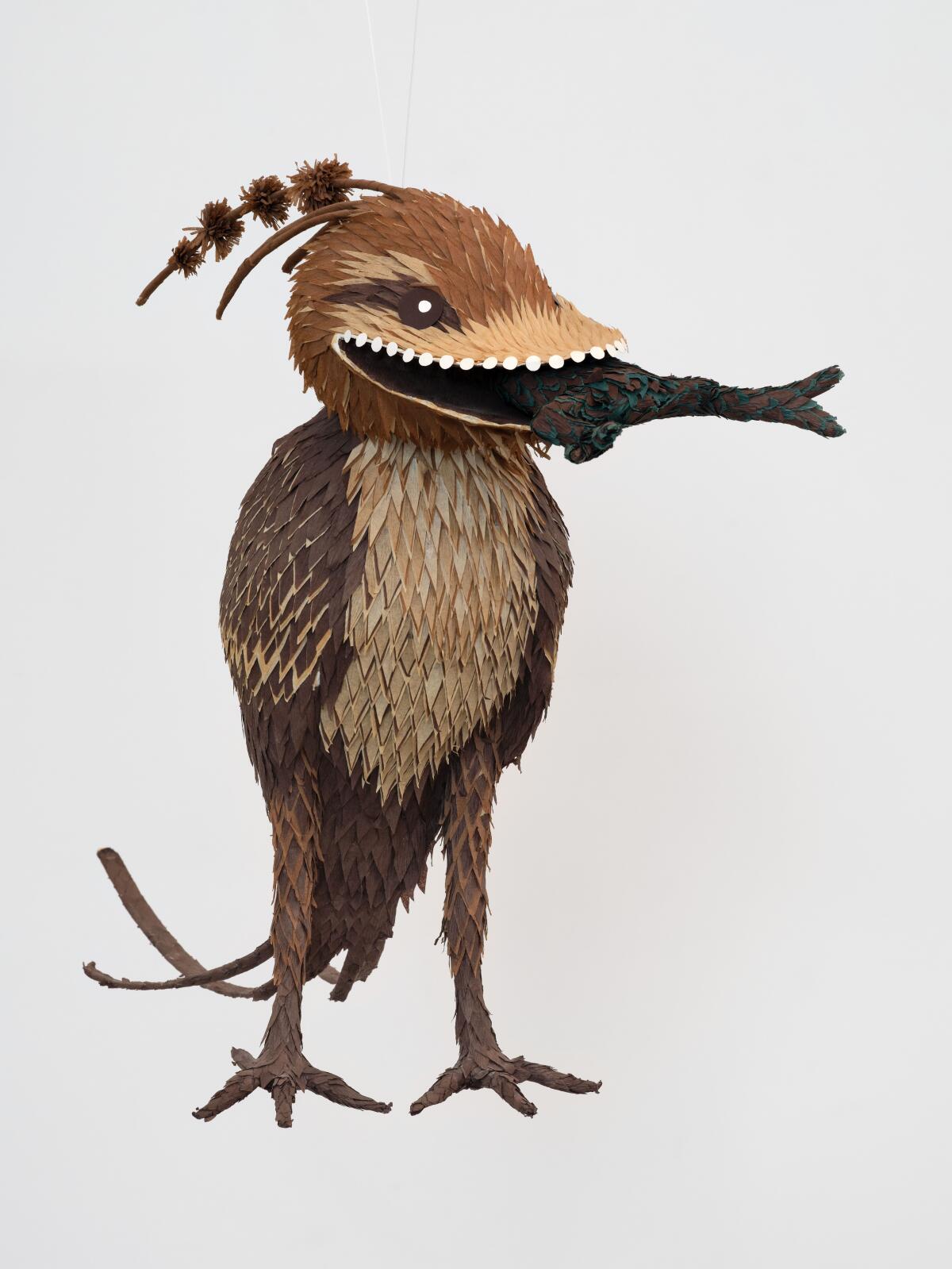 "Bosch Bird No. 3, 2014," by Roberto Benavidez. Newspaper, paperboard, glue, party streamers, wire. 24 x 9 x 18 inches.