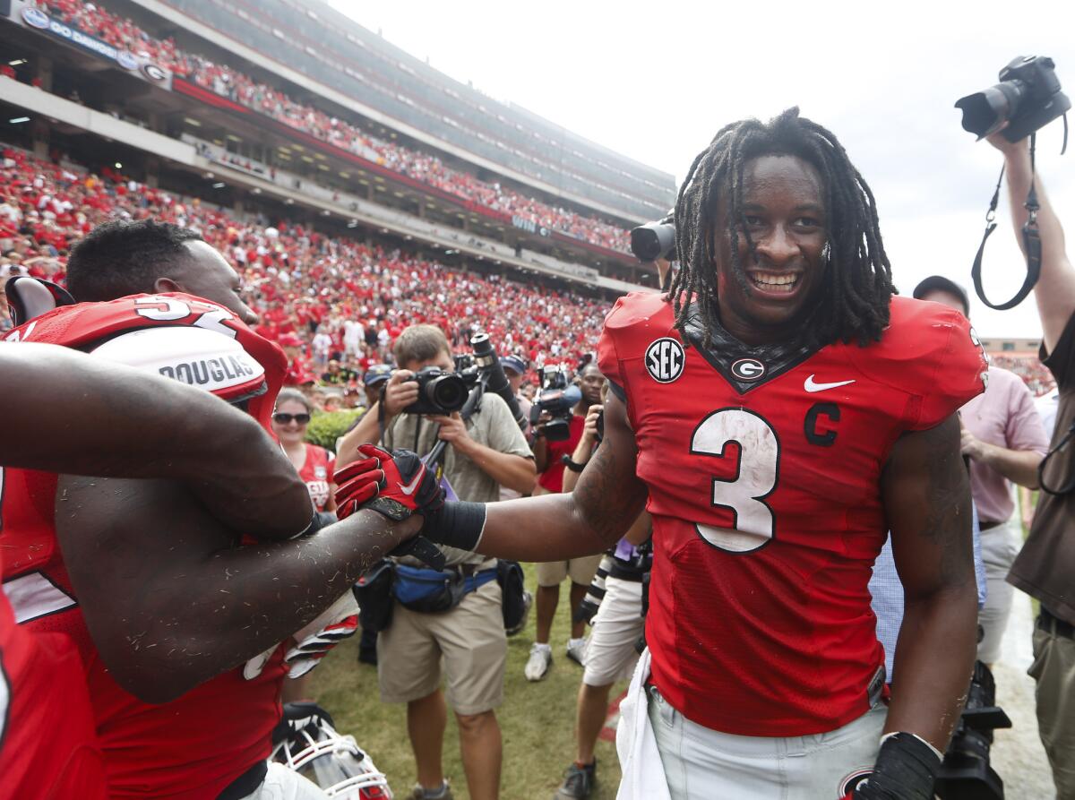 Georgia's Todd Gurley celebrates with teammate Amarlo Herrera during a Sept. 27 game against Tennessee in Athens, Ga.