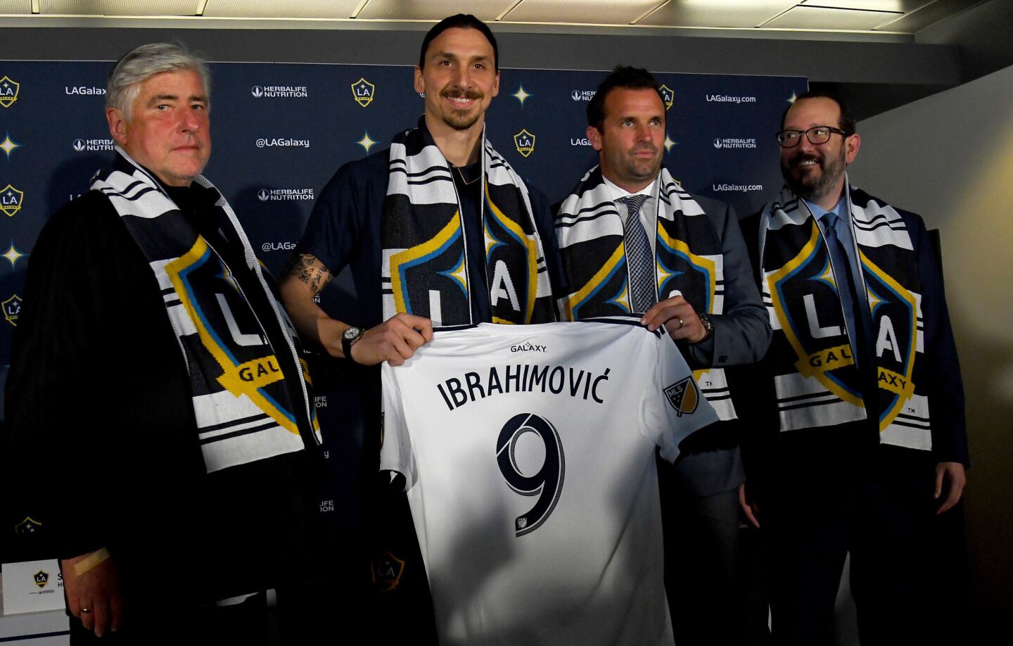 CARSON, CA - MARCH 30: Zlatan Ibrahimovic #9 of the Los Angeles Galaxy holds his jersey as he stands with head coach Sigi Schmid, team president Chris Klein and President and CEO of AEG Dan Beckerman during a press conference at StubHub Center on March 30, 2018 in Carson, California. (Photo by Jayne Kamin-Oncea/Getty Images) ** OUTS - ELSENT, FPG, CM - OUTS * NM, PH, VA if sourced by CT, LA or MoD **