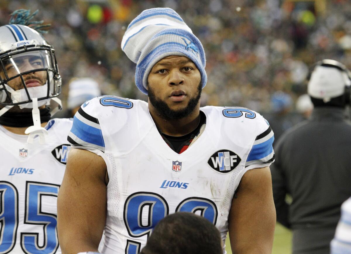 Lions defensive tackle Ndamukong Suh stands on the sideline during a Dec. 28 game against the Packers in Green Bay, Wis.