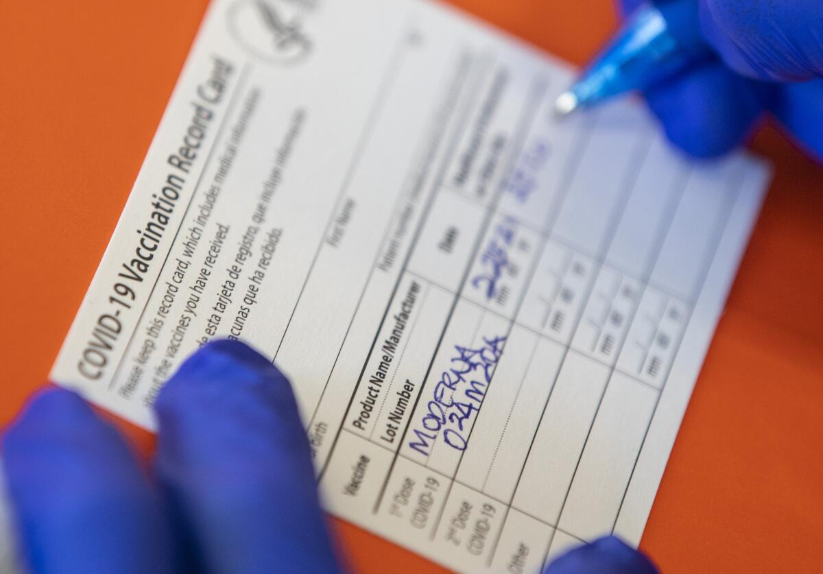 A vaccination record is filled out for a resident of an affordable housing community in Tracy, Calif., on Feb. 25. 