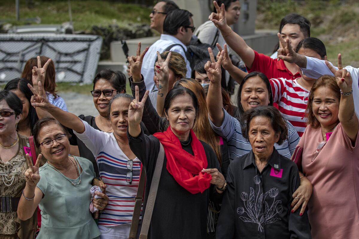 Relatives of victims killed in a 2009 massacre celebrate in Manila following Thursday's guilty verdicts. Five key members of the Ampatuan family were sentenced to life in prison for the killings.