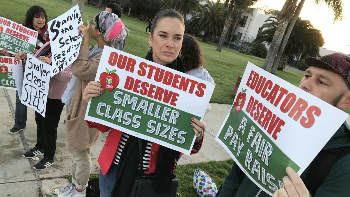 Timothy Hayes right, and Anastasia Foster, center, joined supporters of LAUSD teachers in front of Venice High School for a rally to show their solidarity with the educators and UTLA's call for lower class sizes Thursday morning.