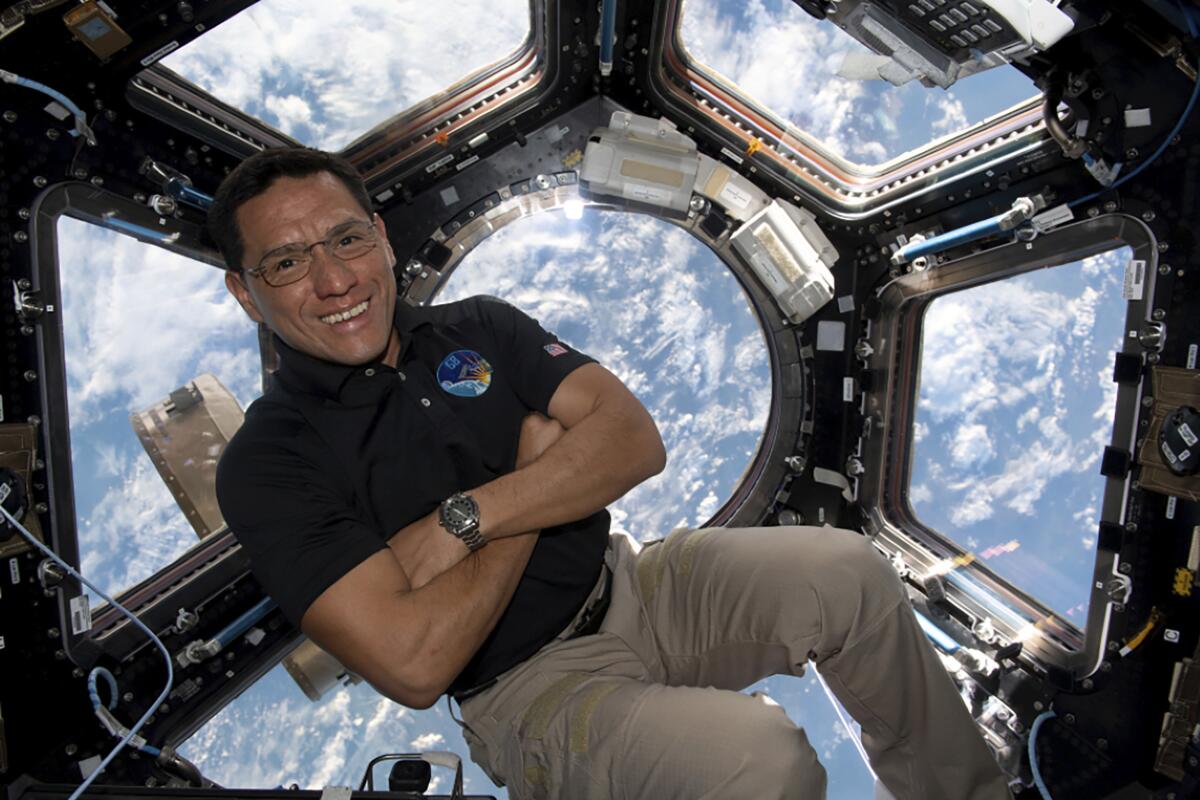 This image provided by NASA shows astronaut Frank Rubio floating inside the cupola, the International Space Stations window to the world. Rubio now holds the record for the longest U.S. spaceflight. Rubio surpassed the U.S. record of 355 days on Monday, Sept. 11, 2023 at the International Space Station. He arrived at the outpost last September with two Russians for a routine six months. (NASA via AP)