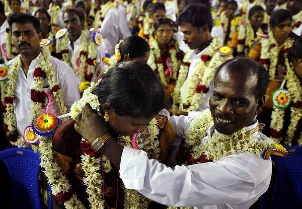 A couple take part in a mass marriage ceremony this month in Chennai. Marriages in India, 90% of which are arranged, are more a merging of clans than a union of two people.