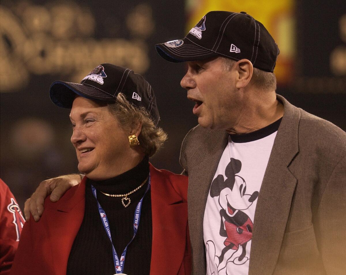Jackie Autry and Michael Eisner after the Championship trophy was handed to Angel manager Mike Scioscia