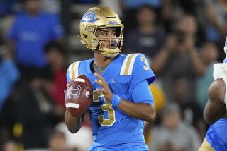 UCLA quarterback Dante Moore scans the field and gets set to pass during a game