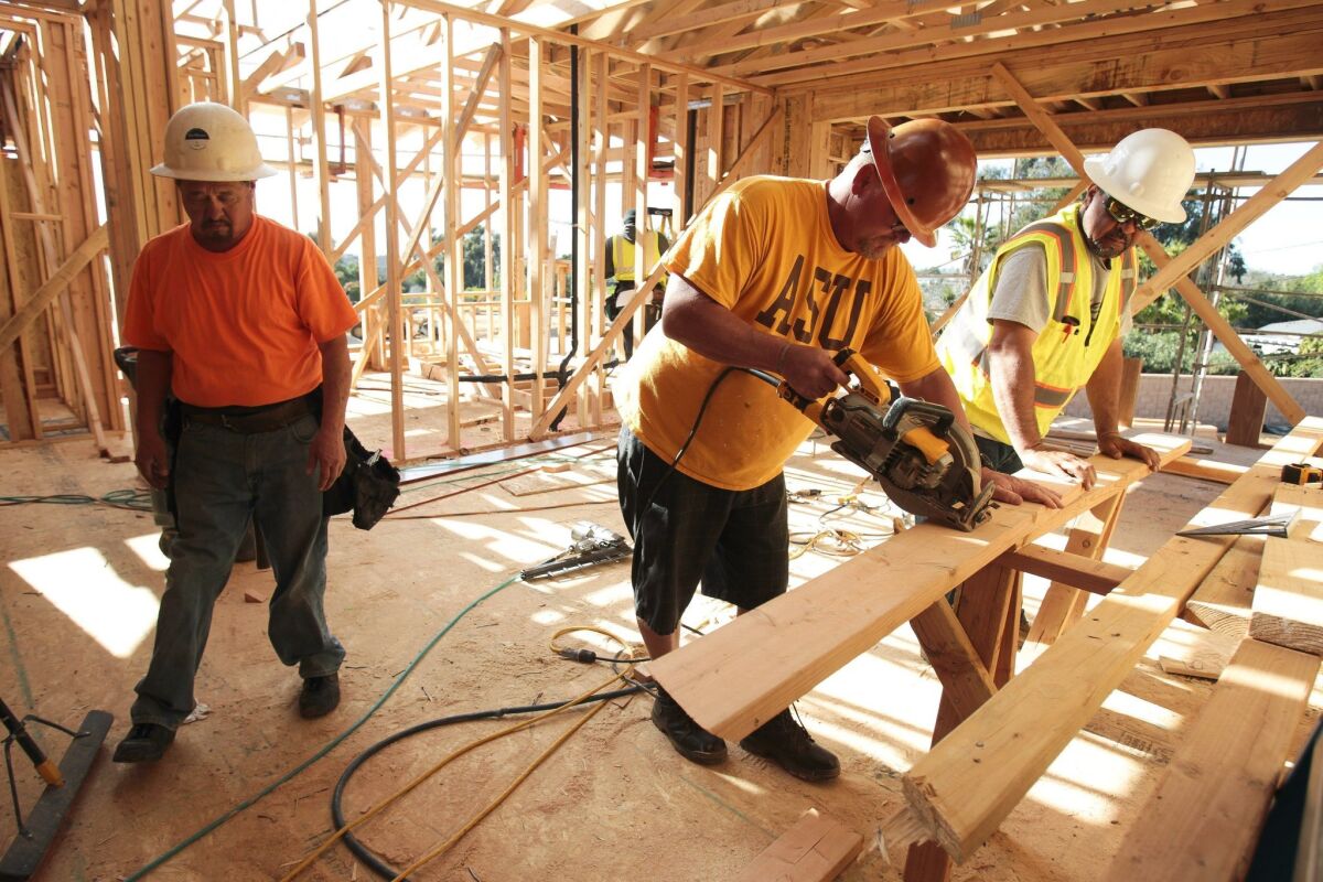 Workers build a home in north San Diego County in this 2016 file photo. If voters approve Measure A, building significant new housing in broad parts of San Diego County would face a new hurdle.