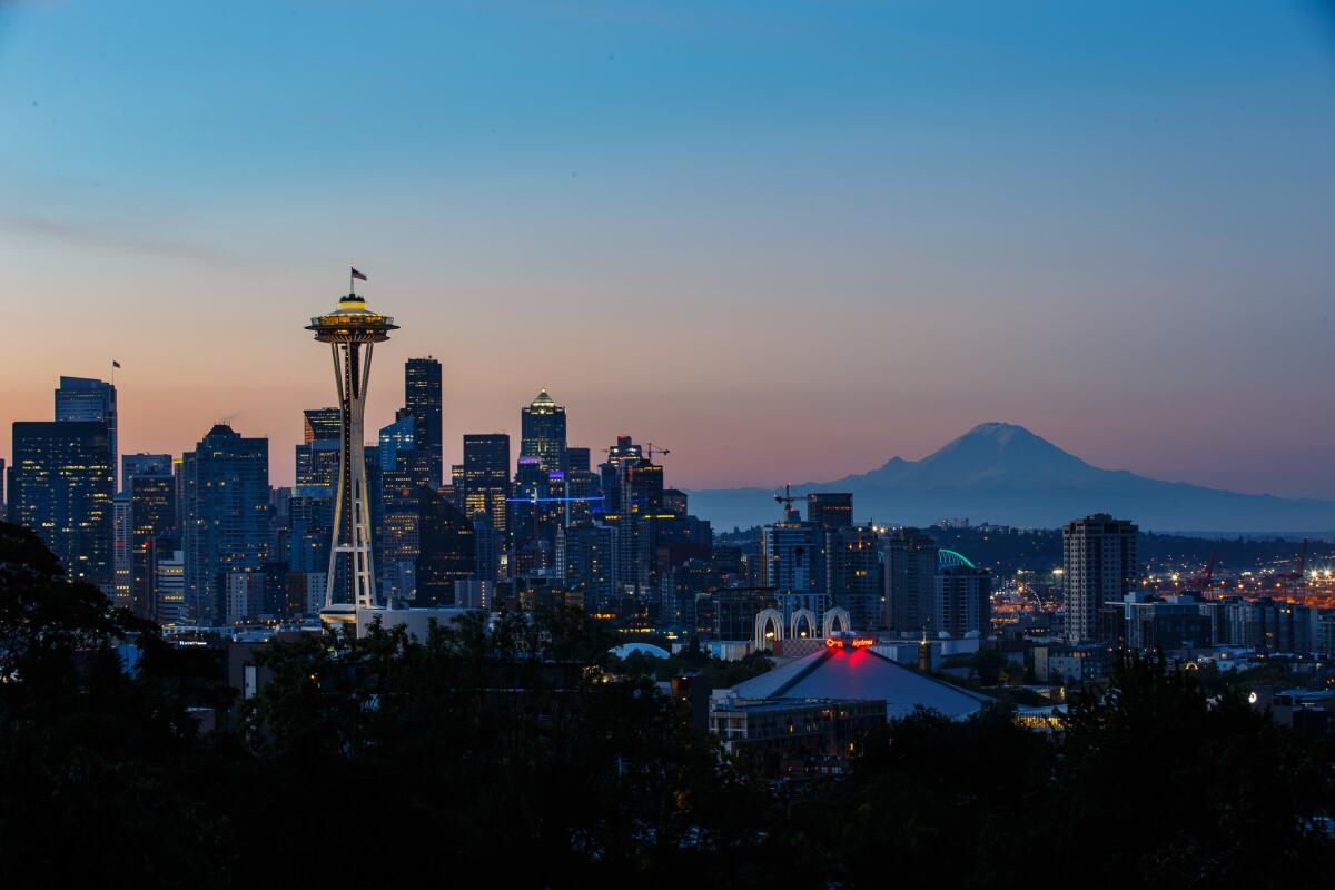 A view of the Seattle Skyline with Mount Rainier and the Space Needle in sight, in Seattle, Wash.