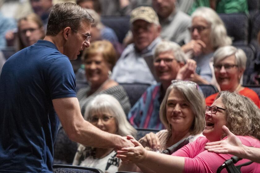 U.S. Rep. Justin Amash, R-Cascade Township, greets the crowd before holding a town hall meeting at Grand Rapids Christian High School's DeVos Center for Arts and Worship on Tuesday, May 28, 2019. The congressman came under scrutiny May 18 when he posted a series of Tweets to outline his support for impeachment proceedings. As such, he is the only Republican congress member to do so. The following days brought an announcement from the wealthy DeVos family about no longer supporting him financially. (Cory Morse/The Grand Rapids Press via AP)