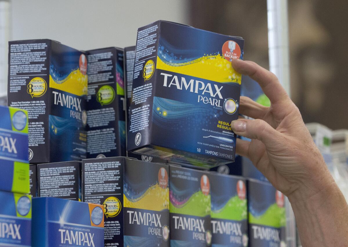 A stack of boxed tampons in a store.