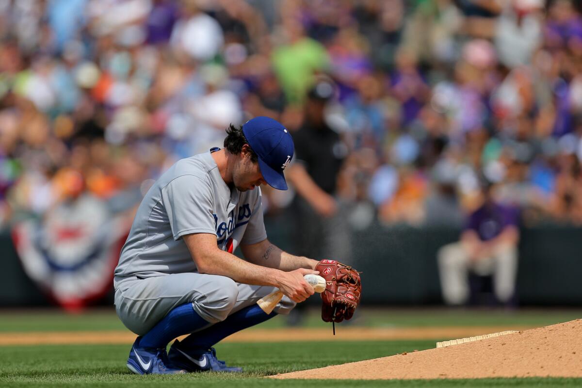 Dodgers pitcher Dan Haren takes a moment to himself after giving up a two-run home run to Colorado's Drew Stubbs during the third inning Saturday at Coors Field.